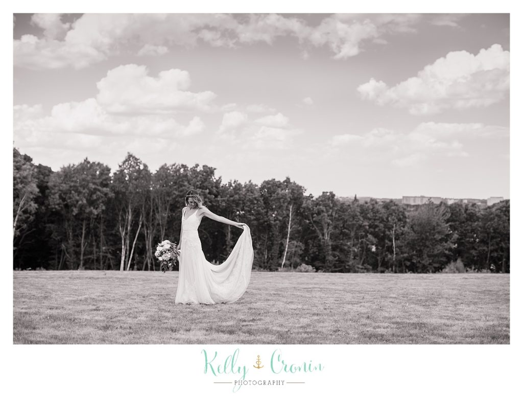 A bride holds her dress | Kelly Cronin Photography | Cape Cod Wedding Photographer