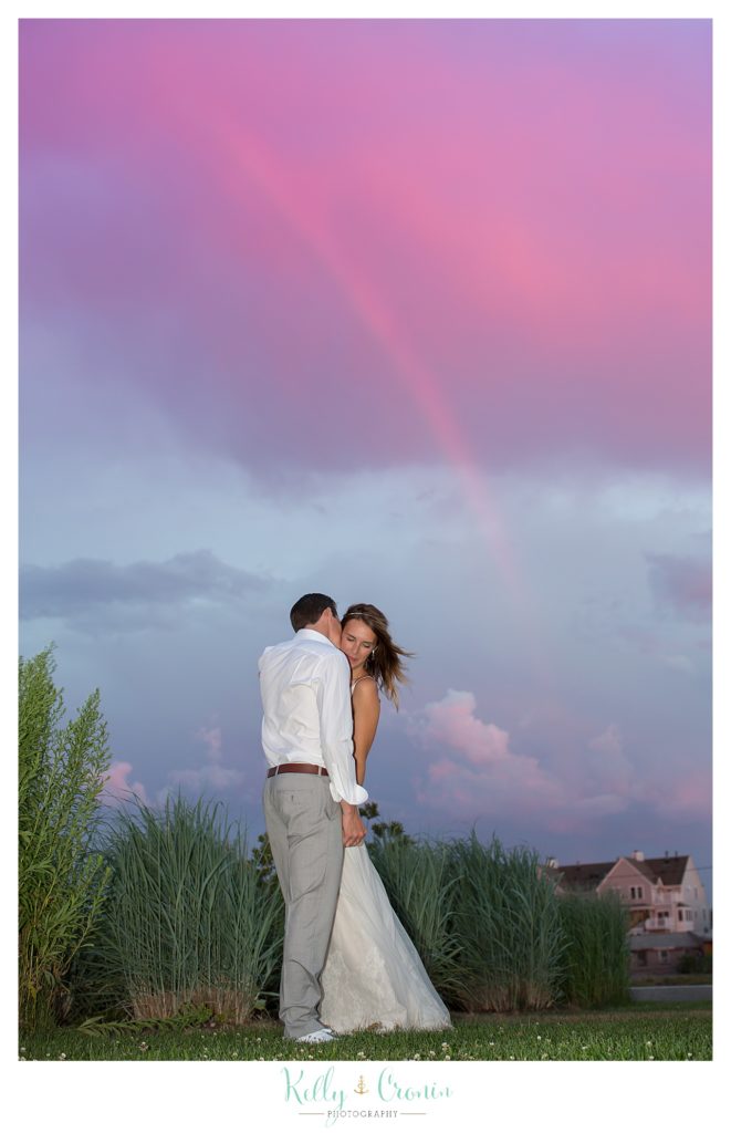 A couple kisses under a rainbow | Kelly Cronin Photography | Cape Cod Wedding Photographer