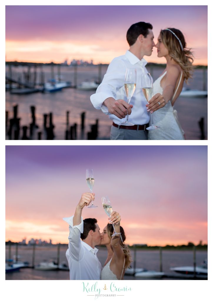 A couple raises their glasses in a toast | Kelly Cronin Photography | Cape Cod Wedding Photographer