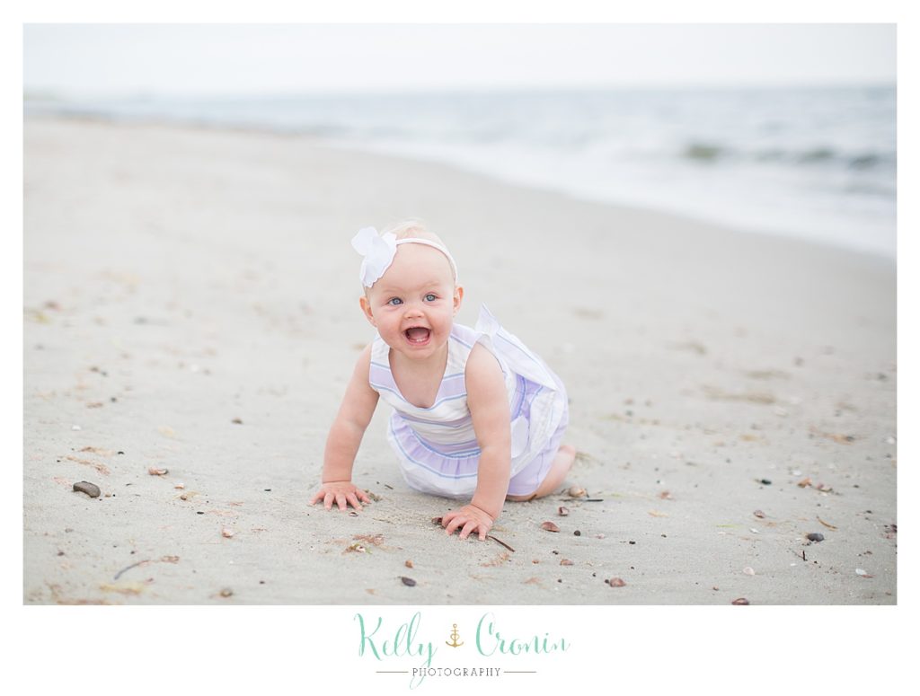 A baby crawls in the sand | Kelly Cronin Photography | Cape Cod Family Photographer