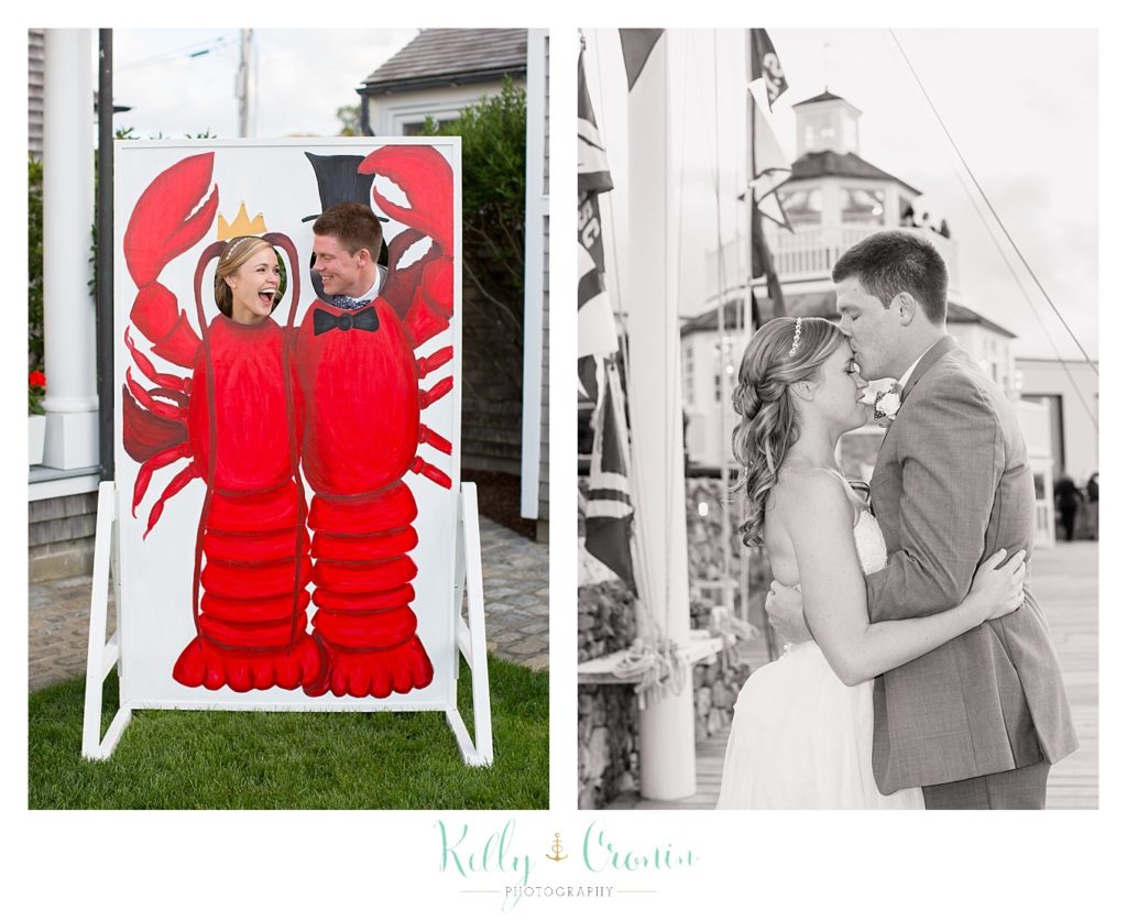 A couple pose behind a lobster cutout | Kelly Cronin Photography | Cape Cod Wedding Photographer