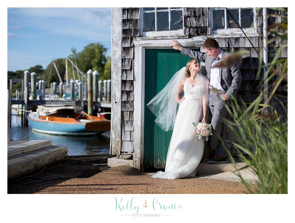 A man leans over his new wife | Kelly Cronin Photography | Cape Cod Wedding Photographer