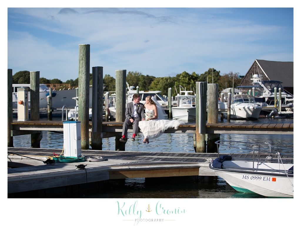 A couple stand on a dock | Kelly Cronin Photography | Cape Cod Wedding Photographer