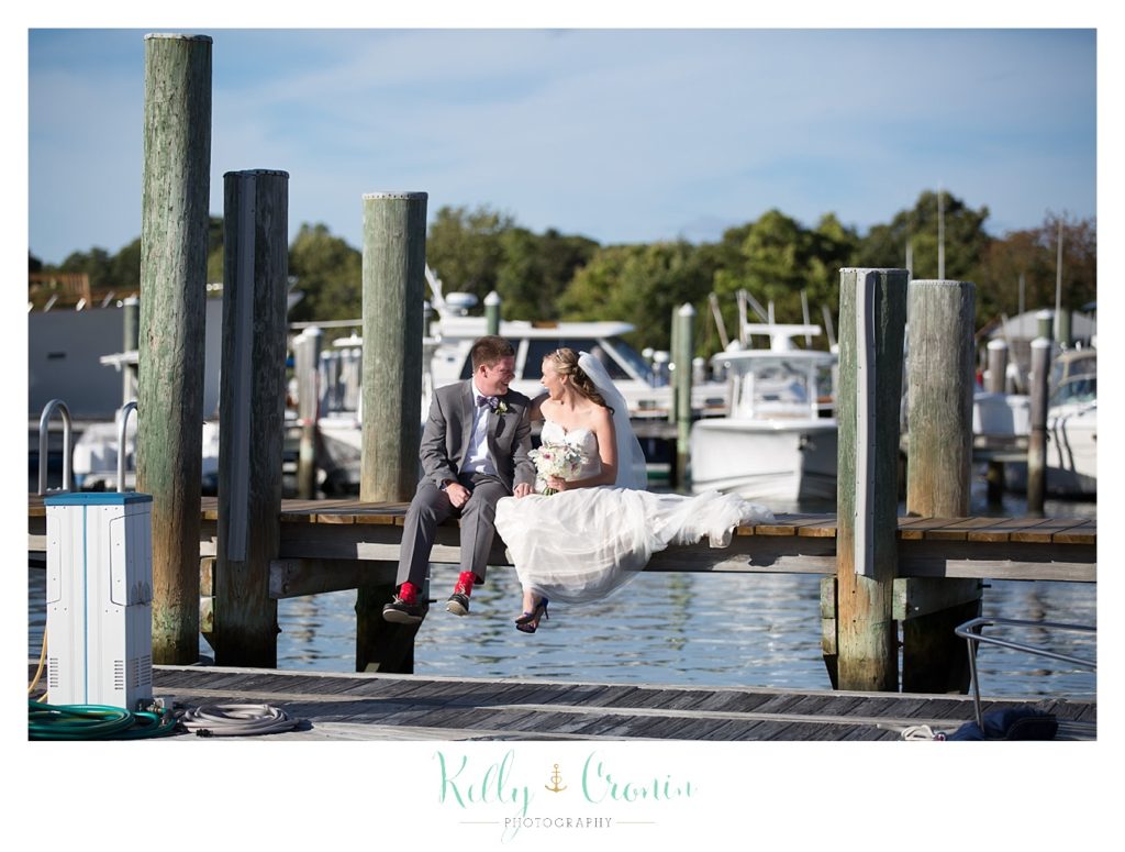 A couple sit on a dock | Kelly Cronin Photography | Cape Cod Wedding Photographer