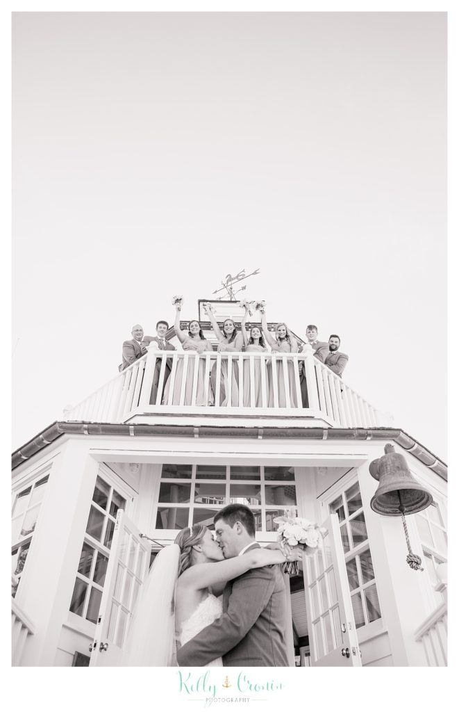 A couple kiss at the top of a light house | Kelly Cronin Photography | Cape Cod Wedding Photographer