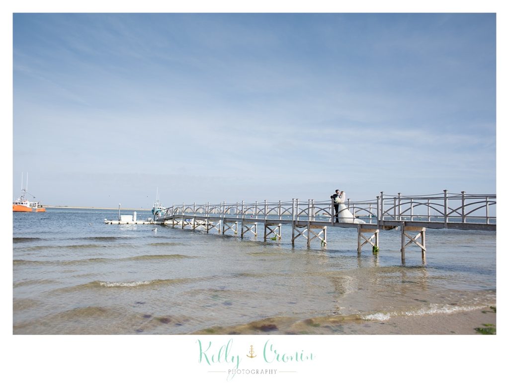 A bride and groom kiss on a dock | Kelly Cronin Photography | Cape Cod Wedding Photographer