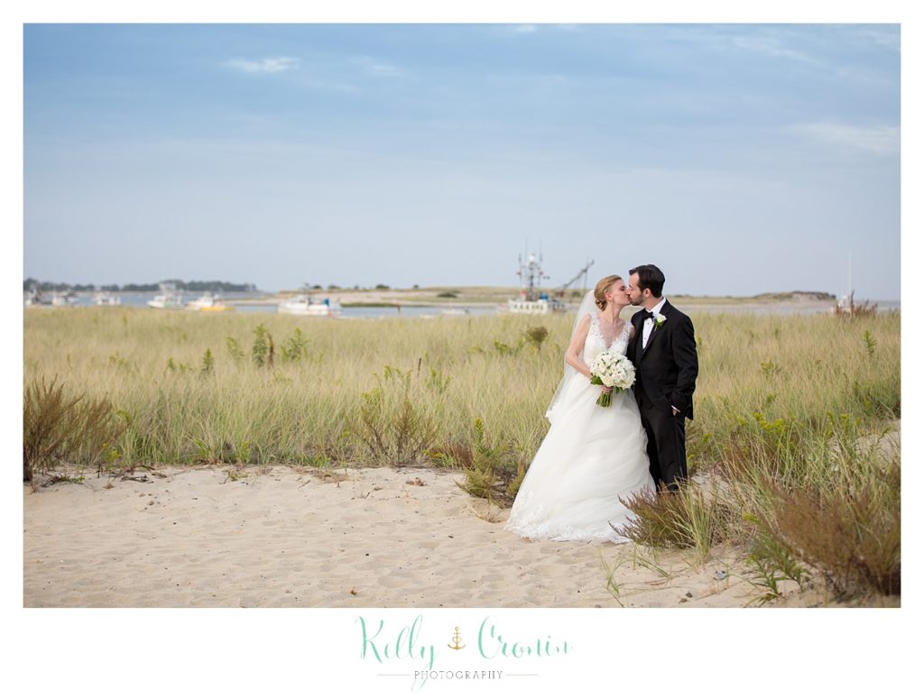 A couple kiss on the beach | Kelly Cronin Photography | Cape Cod Wedding Photographer