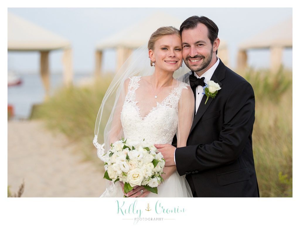 A groom holds his bride | Kelly Cronin Photography | Cape Cod Wedding Photographer