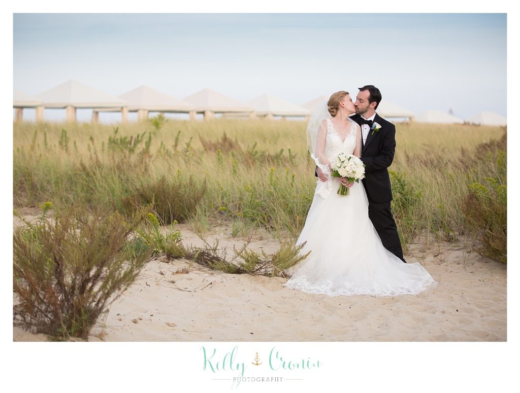 A couple kiss on the shore | Kelly Cronin Photography | Cape Cod Wedding Photographer