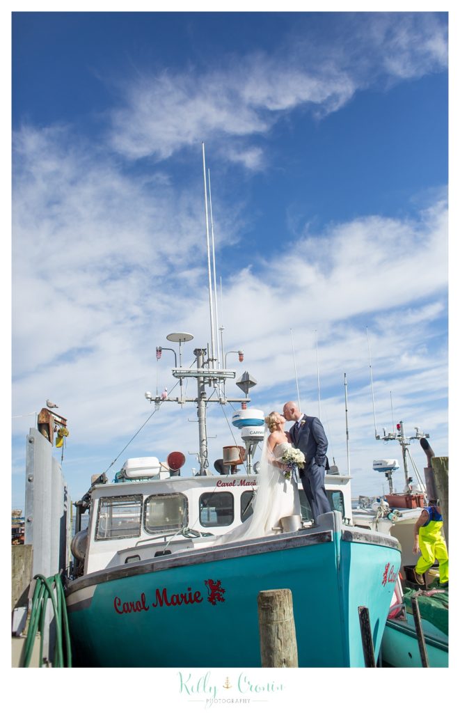 A couple kisses on a boat | Kelly Cronin Photography | Cape Cod Wedding Photographer