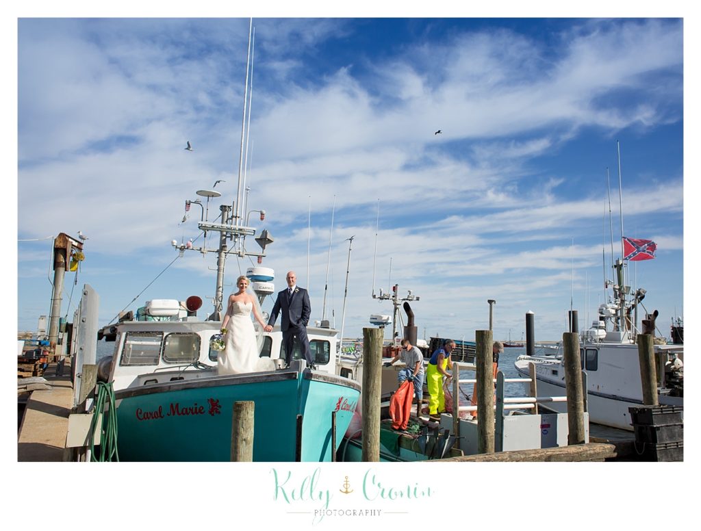 A couple stands on a boat | Kelly Cronin Photography | Cape Cod Wedding Photographer