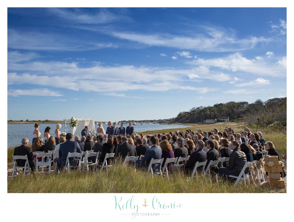 Guests sit for a wedding | Kelly Cronin Photography | Cape Cod Wedding Photographer