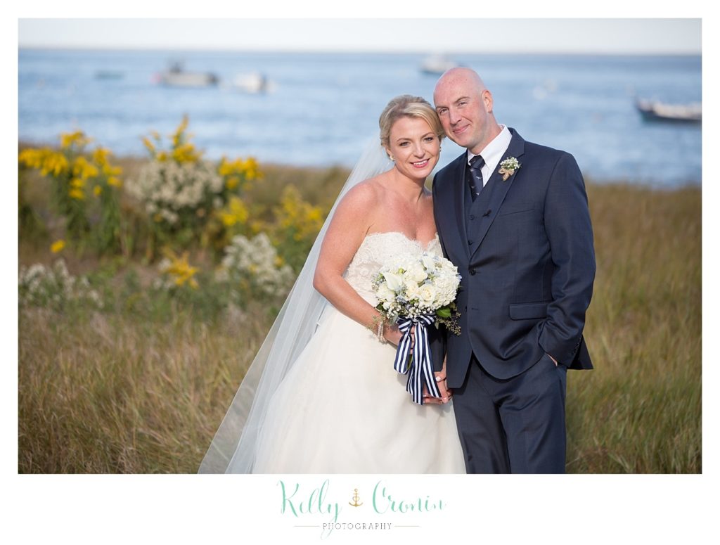 Anewlywed couple stands together | Kelly Cronin Photography | Cape Cod Wedding Photographer