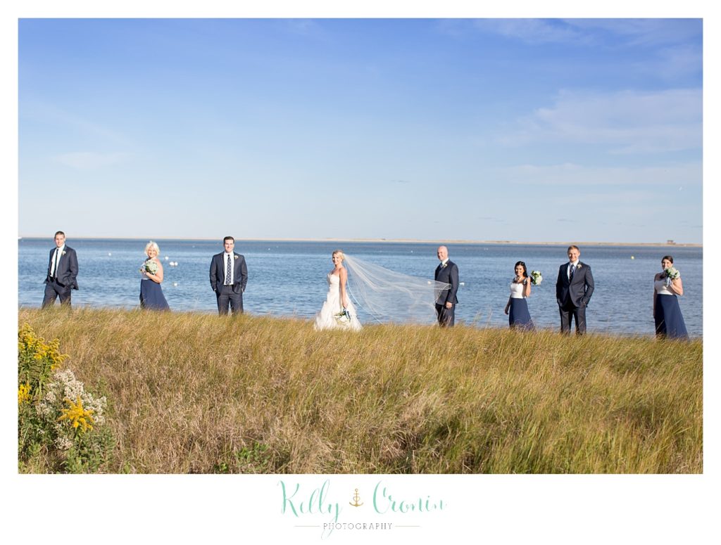 A bride stand| Kelly Cronin Photography | Cape Cod Wedding Photographers with her groom 