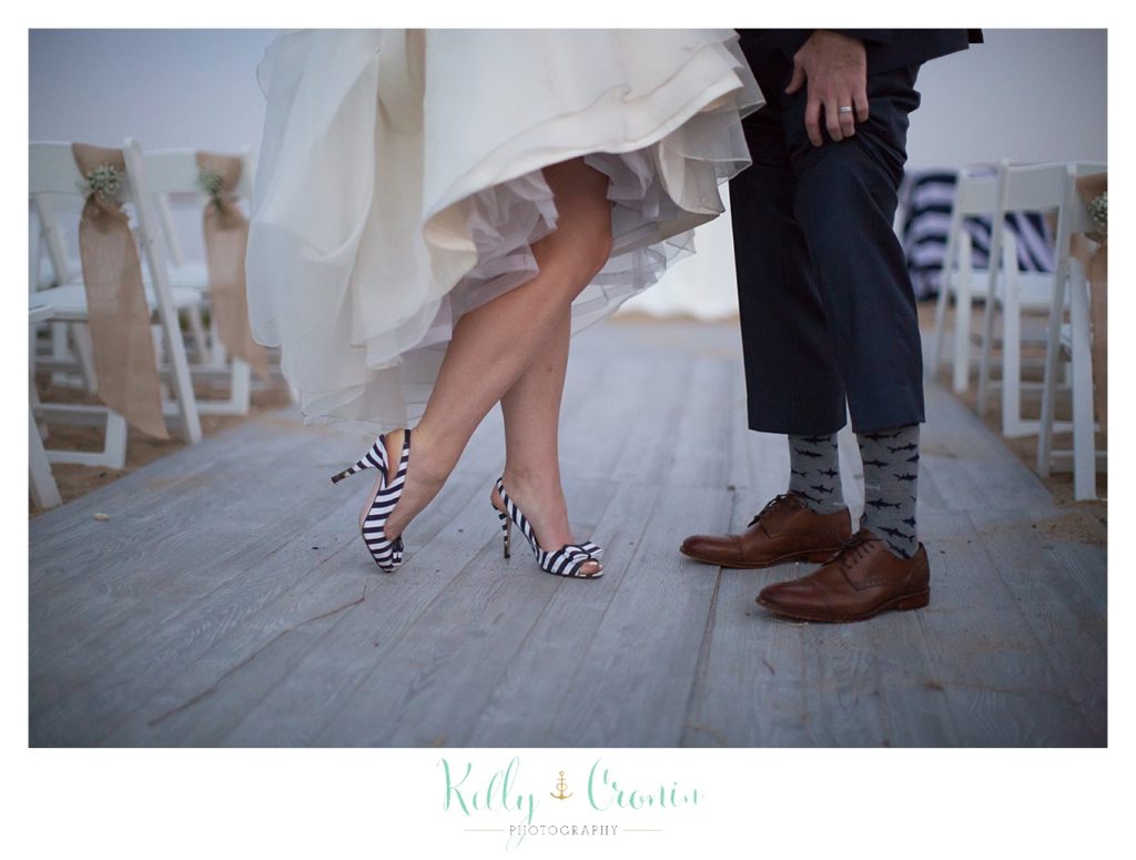 A woman hikes up her dress | Kelly Cronin Photography | Cape Cod Wedding Photographer