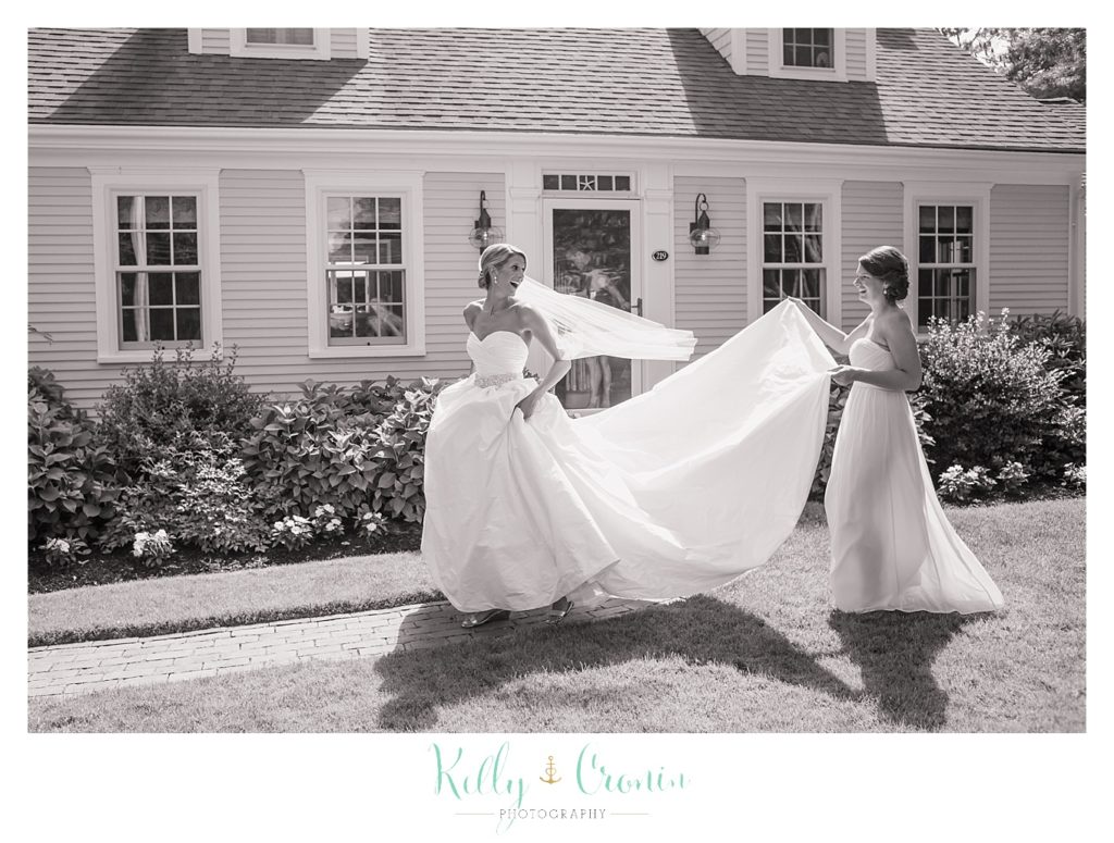 A woman stands in a wedding dress  | Kelly Cronin Photography | Cape Cod Wedding Photographer