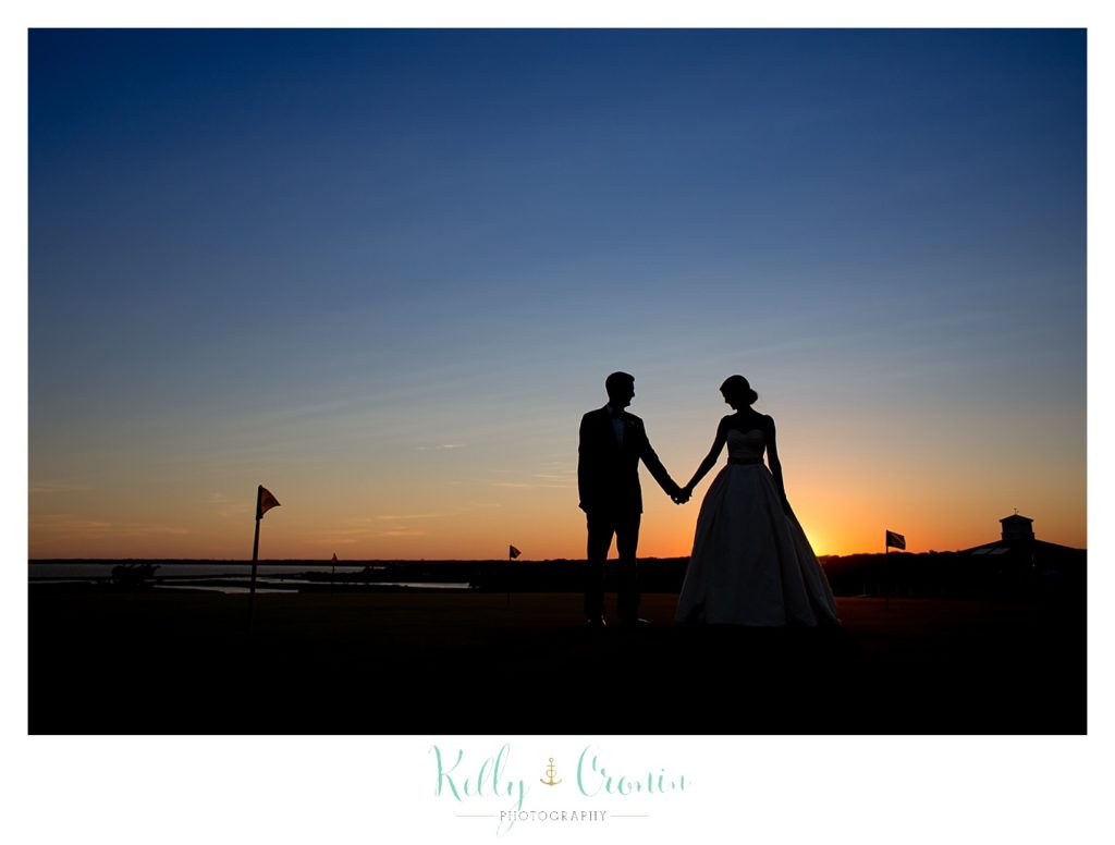 A couple walk into the sunset  | Kelly Cronin Photography | Cape Cod Wedding Photographer