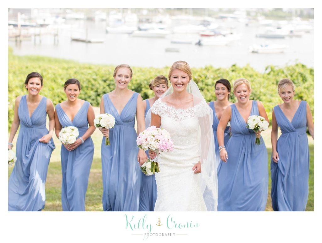 A woman stands in front of her bridal party  | Kelly Cronin Photography | Cape Cod Wedding Photographer