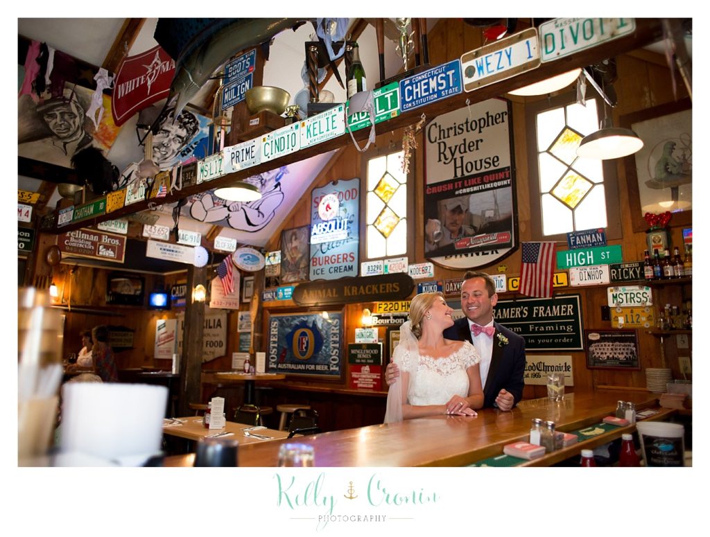 A woman sits with her husband  | Kelly Cronin Photography | Cape Cod Wedding Photographer