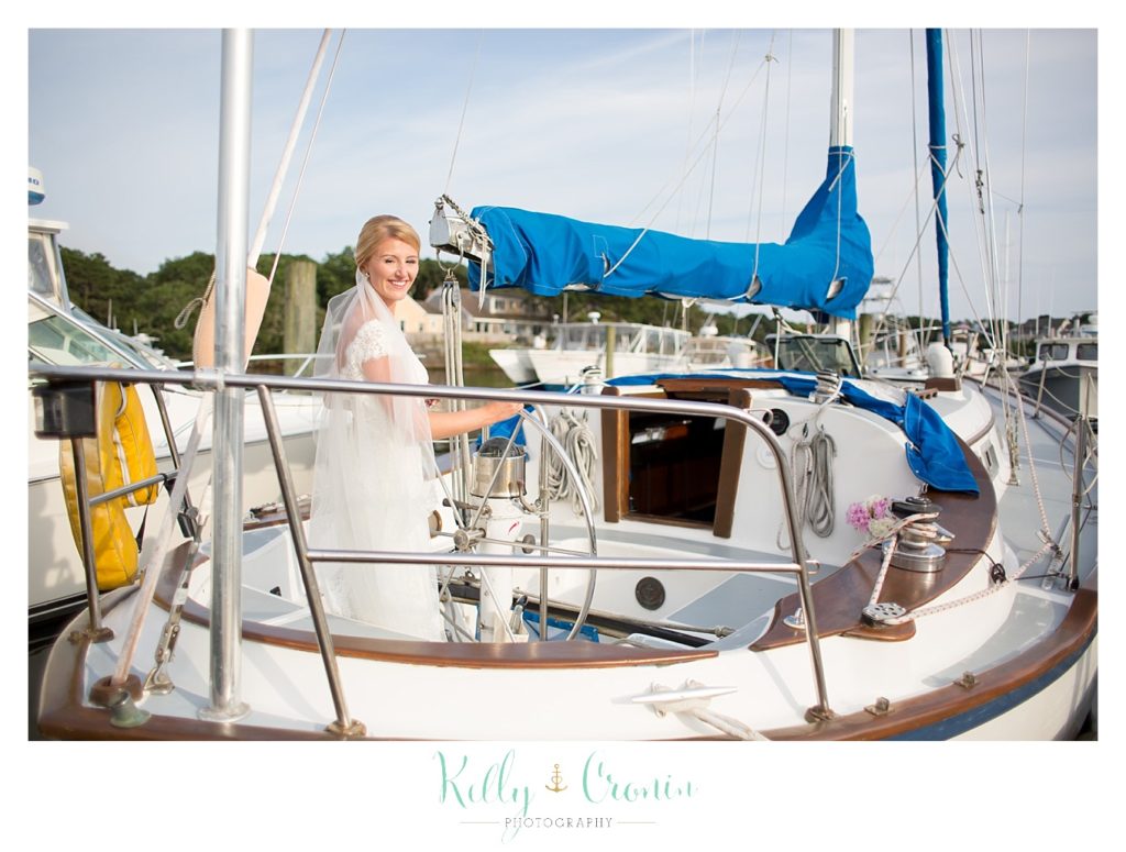 A bride boards a boat  | Kelly Cronin Photography | Cape Cod Wedding Photographer