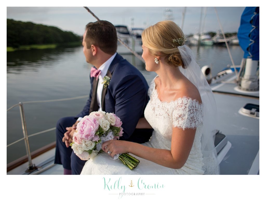 A couple sail together  | Kelly Cronin Photography | Cape Cod Wedding Photographer
