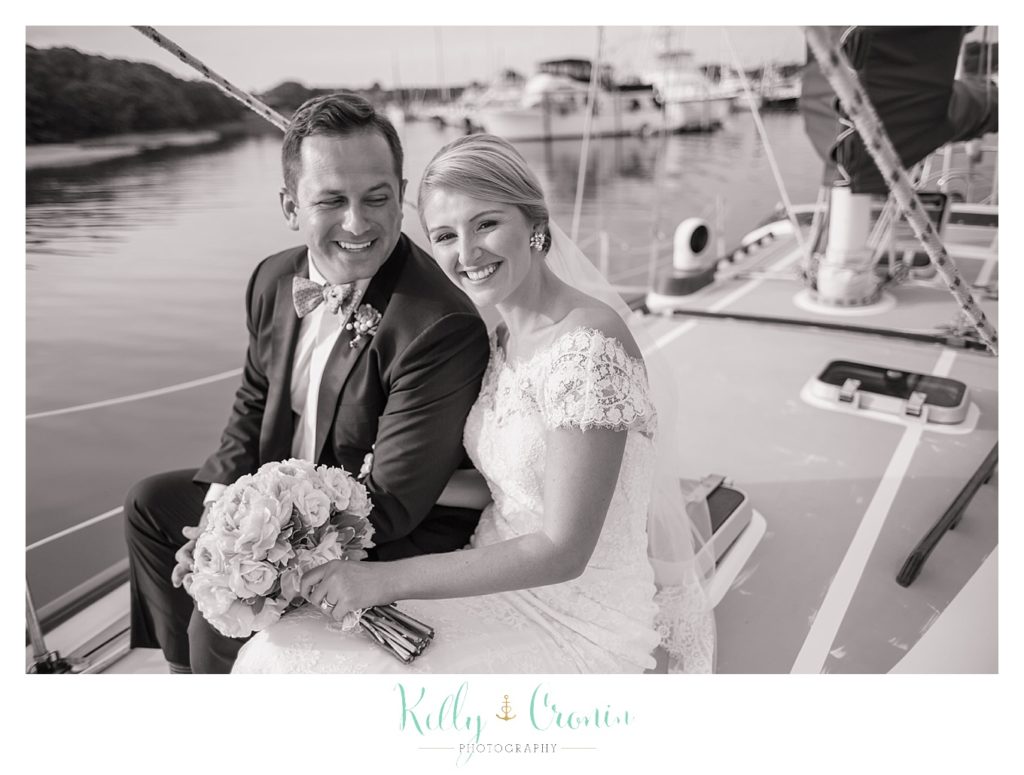 A man sails with his bride  | Kelly Cronin Photography | Cape Cod Wedding Photographer