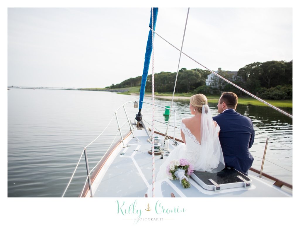 A couple sail to their wedding party  | Kelly Cronin Photography | Cape Cod Wedding Photographer