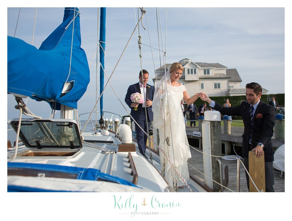A couple get off of a boat  | Kelly Cronin Photography | Cape Cod Wedding Photographer