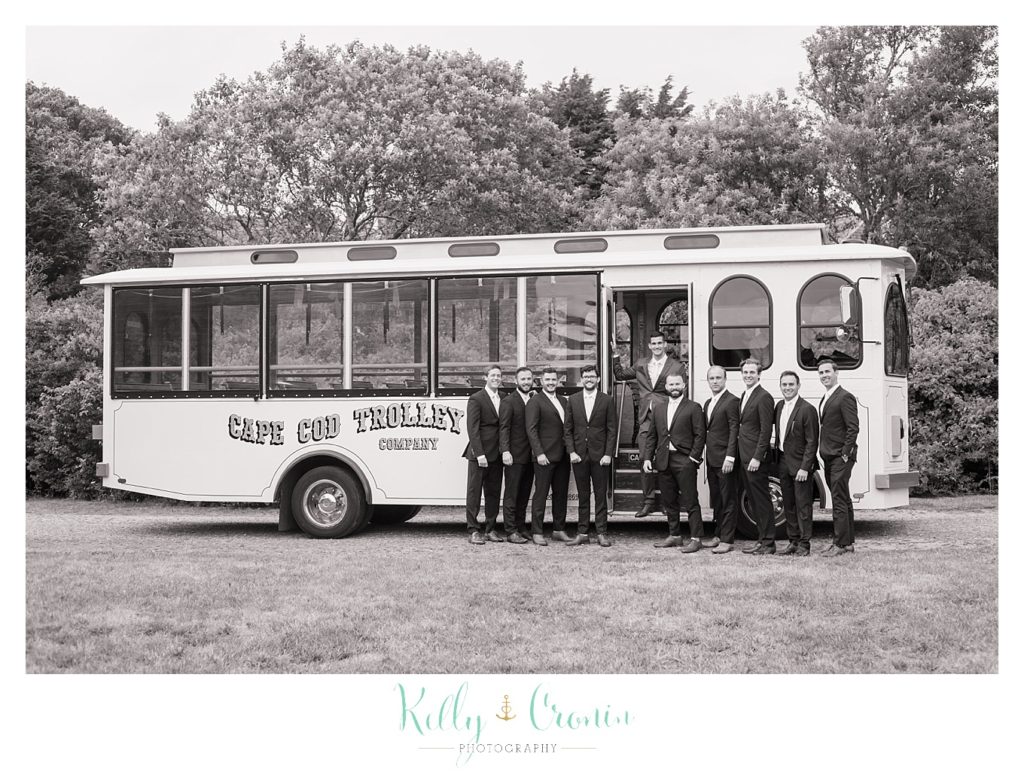 A groom's party stands in front of a trolly | Kelly Cronin Photography | Cape Cod Wedding Photographer