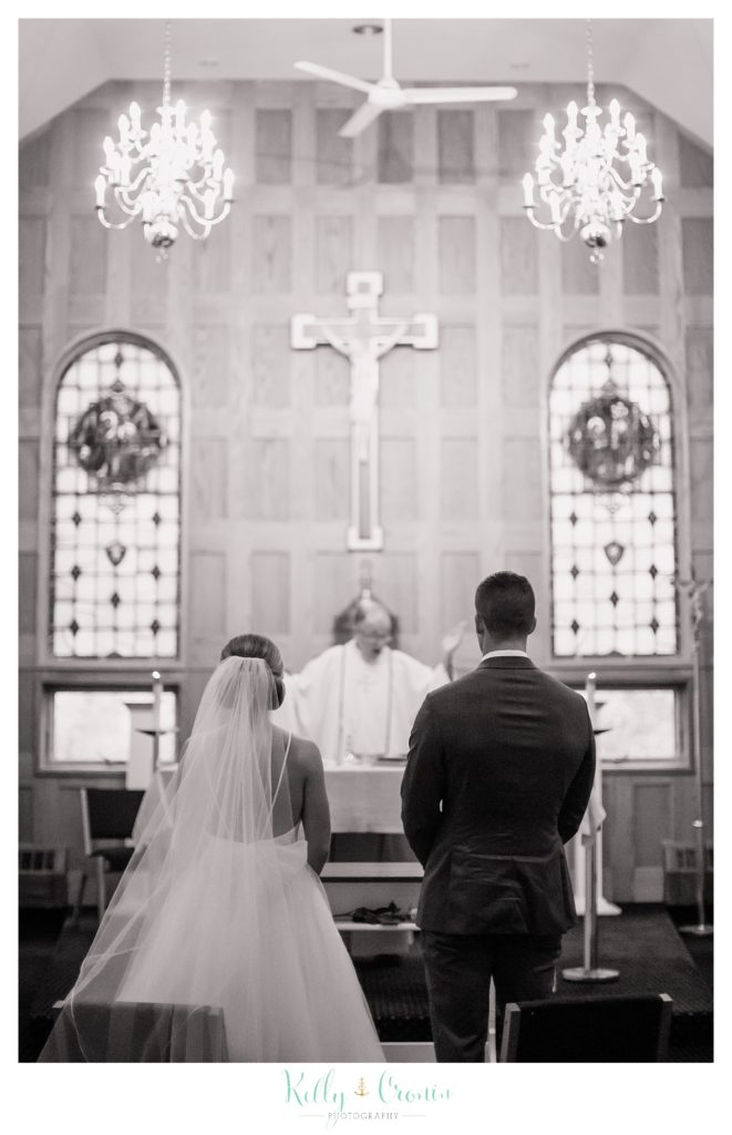 A couple stand before a priest | Kelly Cronin Photography | Cape Cod Wedding Photographer