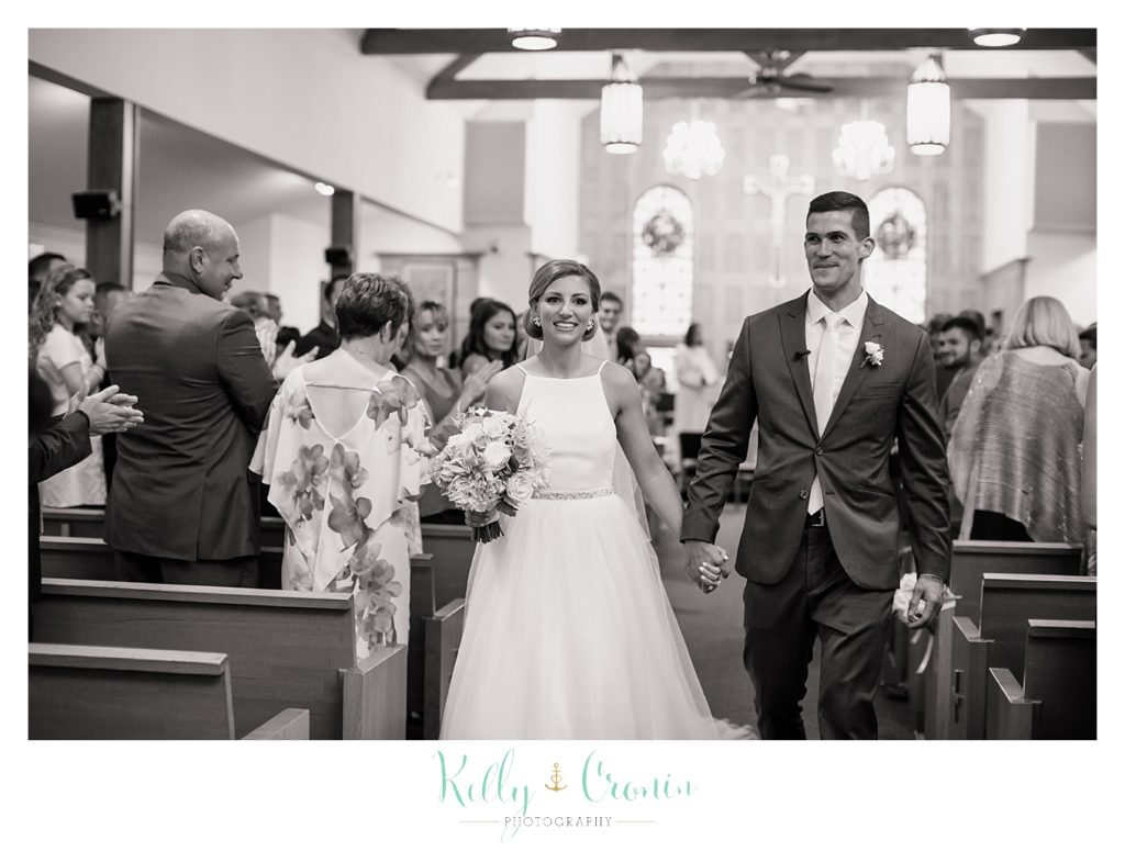 A newlywed couple walk down the aisle | Kelly Cronin Photography | Cape Cod Wedding Photographer