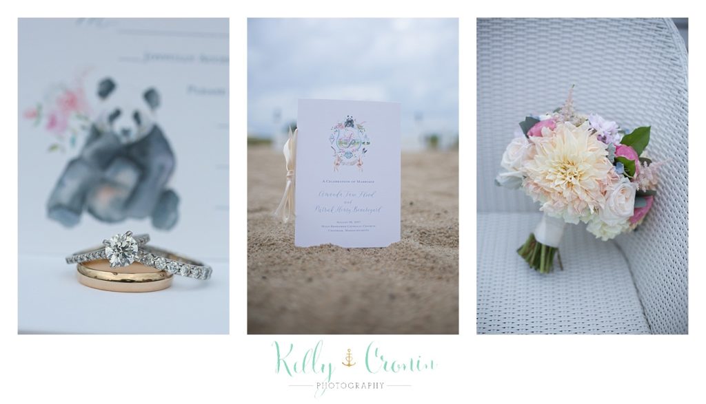 A wedding invitation is sitting in sand | Kelly Cronin Photography | Cape Cod Wedding Photographer