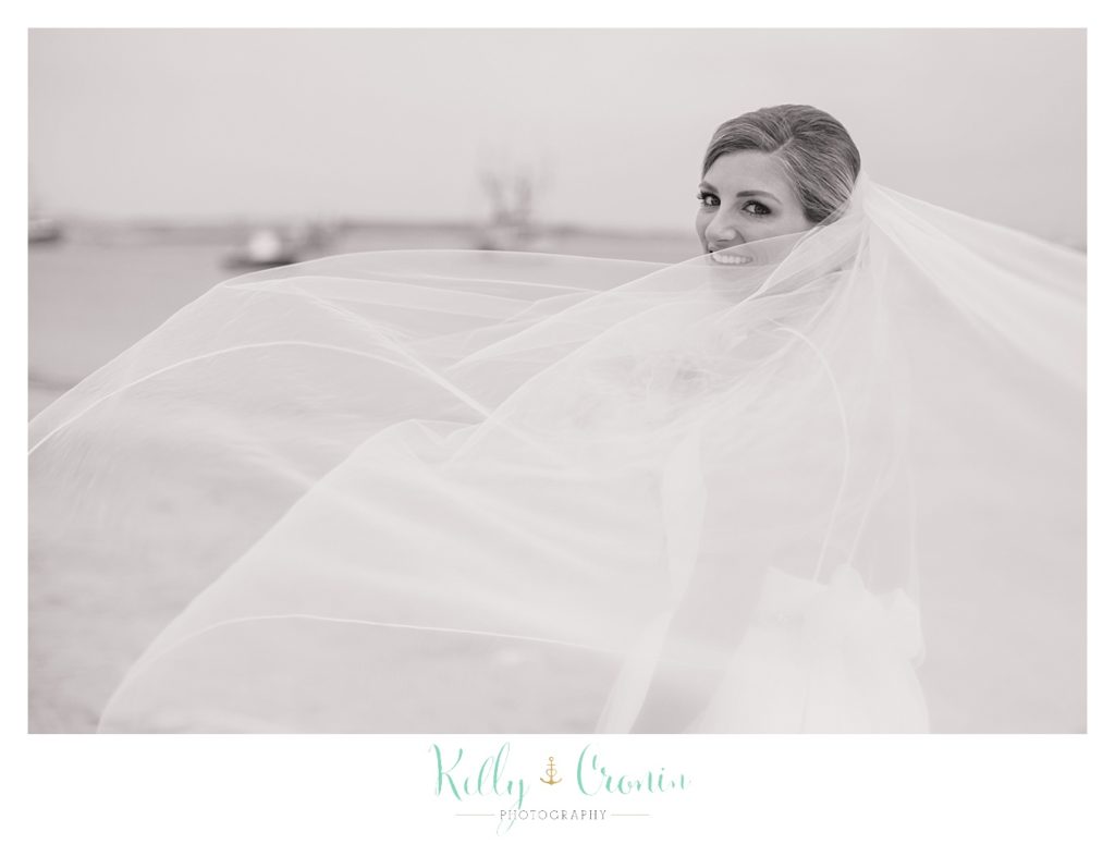 A bride's veil flows in front of her face | Kelly Cronin Photography | Cape Cod Wedding Photographer