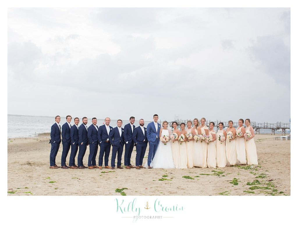 A wedding party stands on the beach | Kelly Cronin Photography | Cape Cod Wedding Photographer
