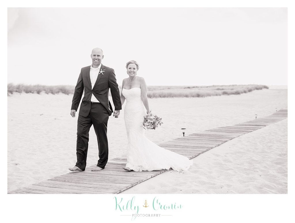 A couple walk down a path | Kelly Cronin Photography | Cape Cod Wedding Photographer