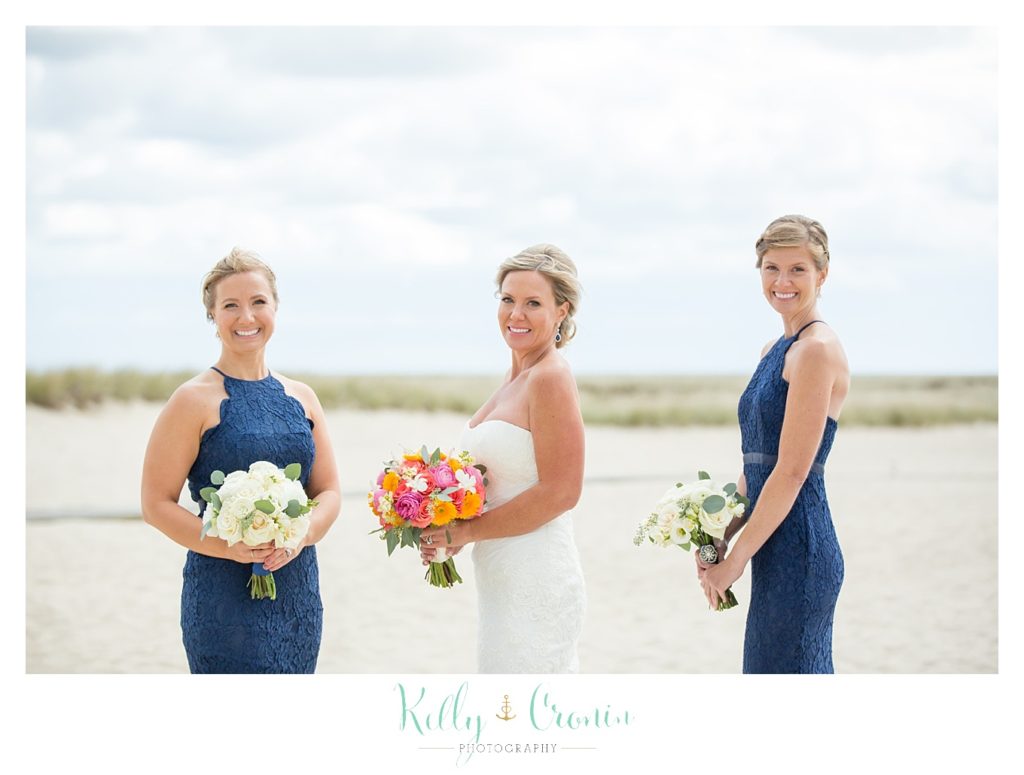 A bride poses with her bridesmaids | Kelly Cronin Photography | Cape Cod Wedding Photographer