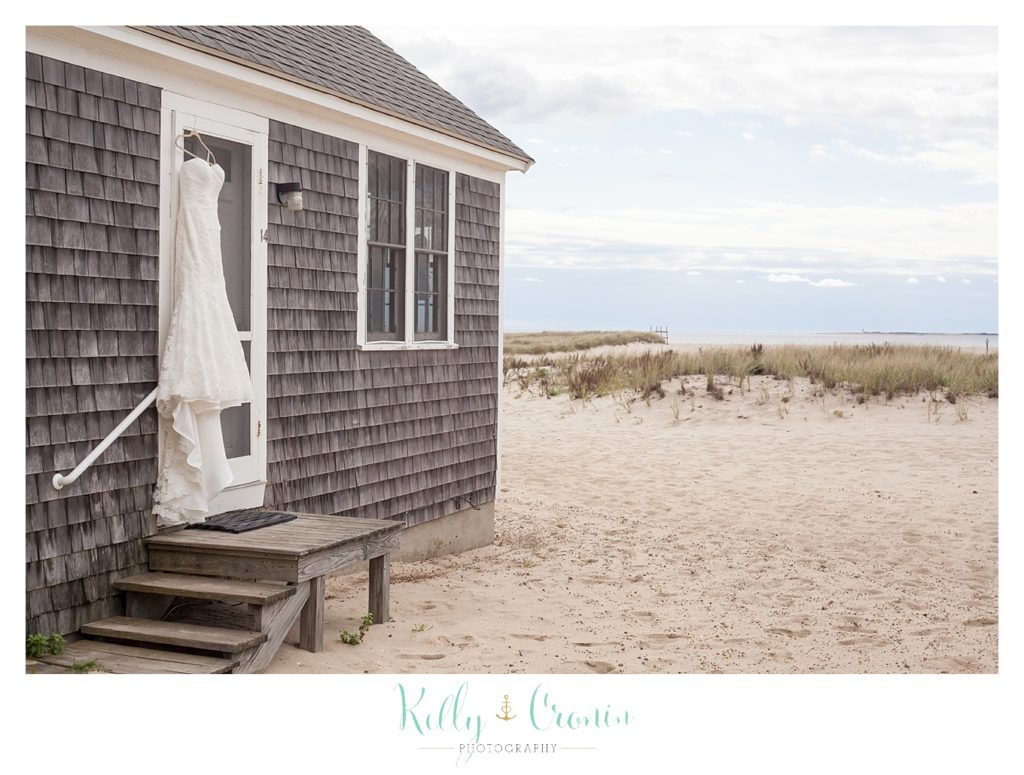 A wedding dress hangs | Kelly Cronin Photography | Cape Cod Wedding Photographer