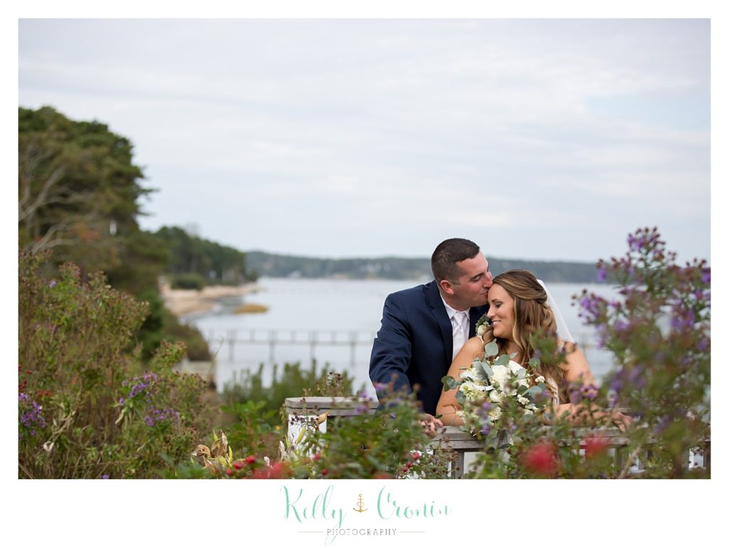 A groom kisses his bride's head | Kelly Cronin Photography | Cape Cod Wedding Photographer