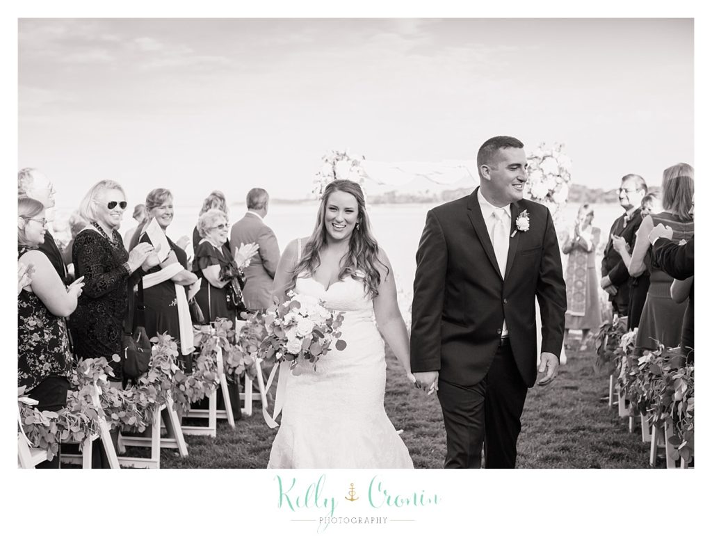 A couple walk the wedding aisle | Kelly Cronin Photography | Cape Cod Wedding Photographer