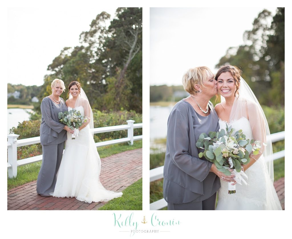 A mother of the bride kisses her daughter | Kelly Cronin Photography | Cape Cod Wedding Photographer