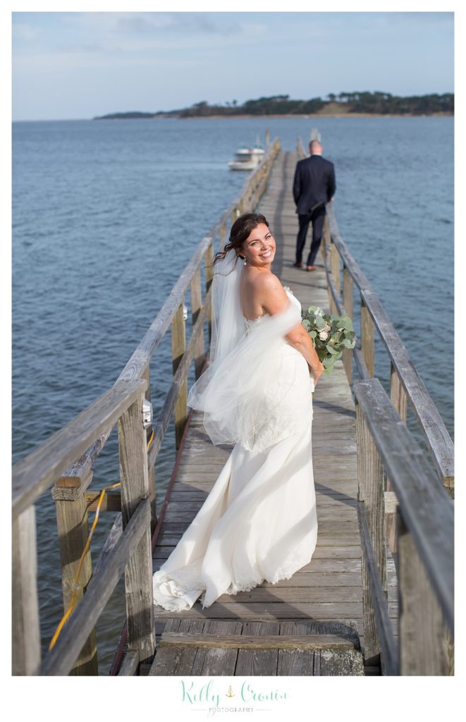 A bride walks on a pier | Kelly Cronin Photography | Cape Cod Wedding Photographer