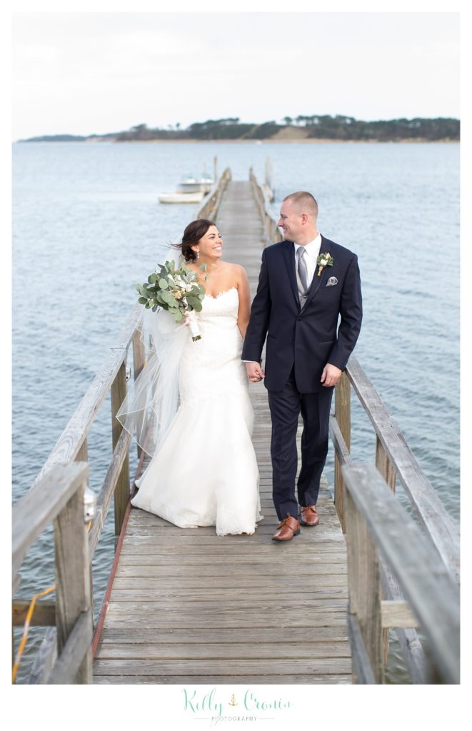 A bride and groom hold hands | Kelly Cronin Photography | Cape Cod Wedding Photographer
