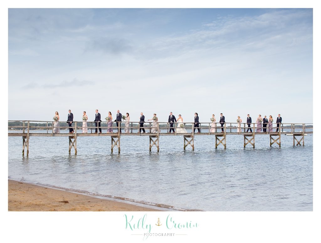 A wedding party stands on a dock | Kelly Cronin Photography | Cape Cod Wedding Photographer