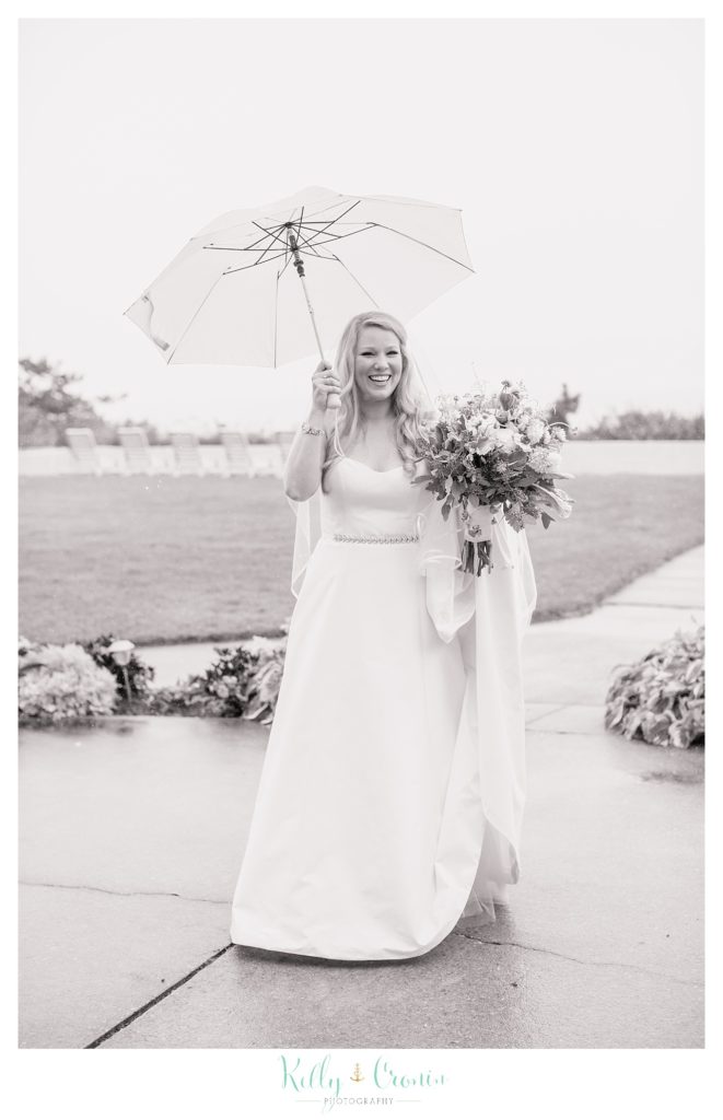 A bride holds an umbrella  | Kelly Cronin Photography | Cape Cod Wedding Photographer