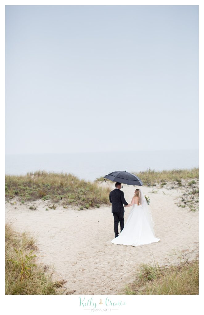A couple walk along the beach  | Kelly Cronin Photography | Cape Cod Wedding Photographer