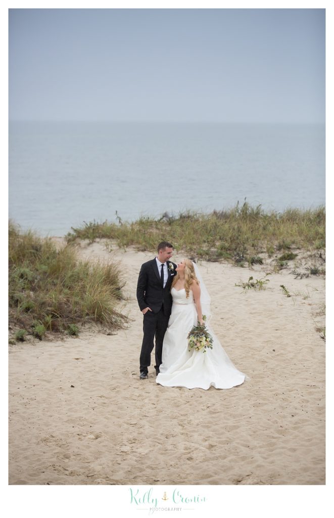 A couple stand on the beach  | Kelly Cronin Photography | Cape Cod Wedding Photographer