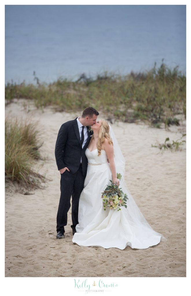 A newlywed couple kiss  | Kelly Cronin Photography | Cape Cod Wedding Photographer
