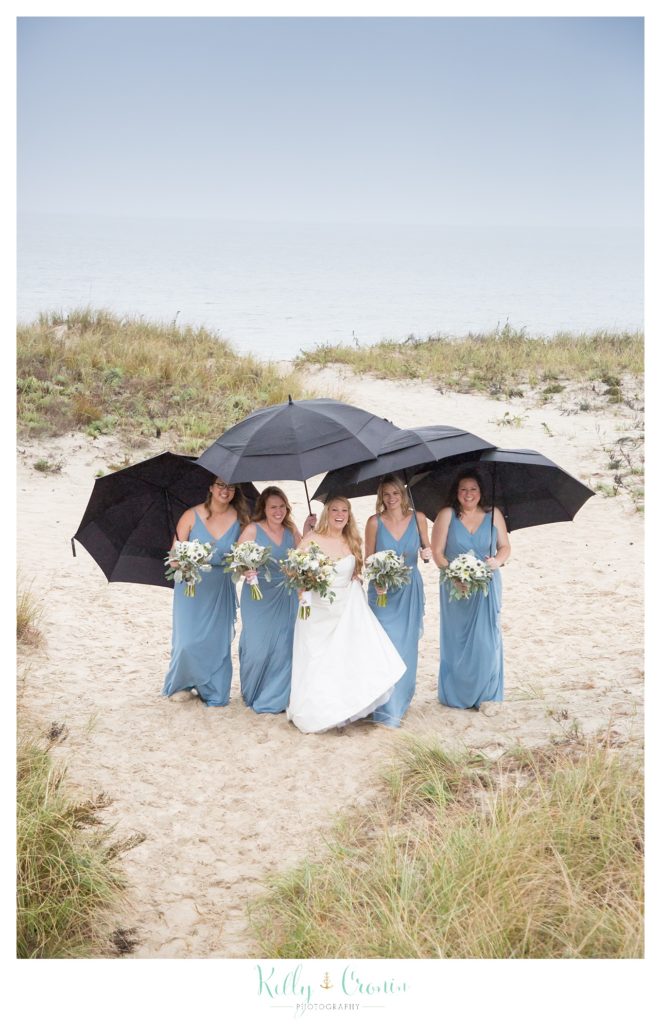 A bridal party holds umbrellas  | Kelly Cronin Photography | Cape Cod Wedding Photographer