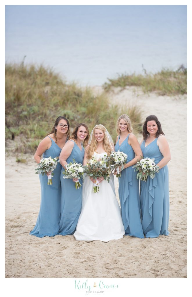 A bride stands with her bridesmaids  | Kelly Cronin Photography | Cape Cod Wedding Photographer