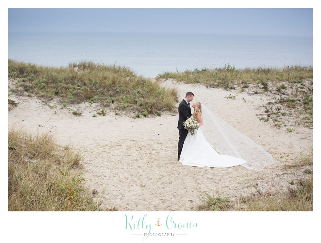 A newlywed couple embrace  | Kelly Cronin Photography | Cape Cod Wedding Photographer